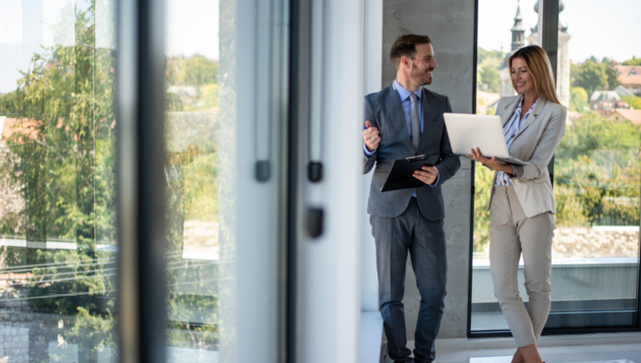 Two real estate agents help with the decision to rent or sell a property